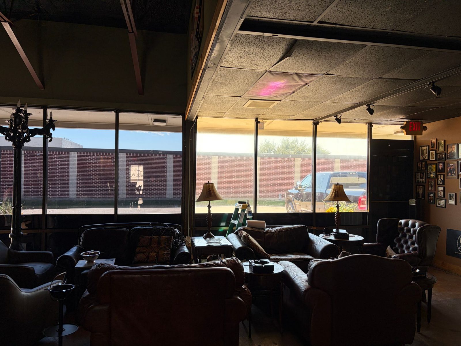 Cigar lounge interior with a clear view out through tinted storefront windows
