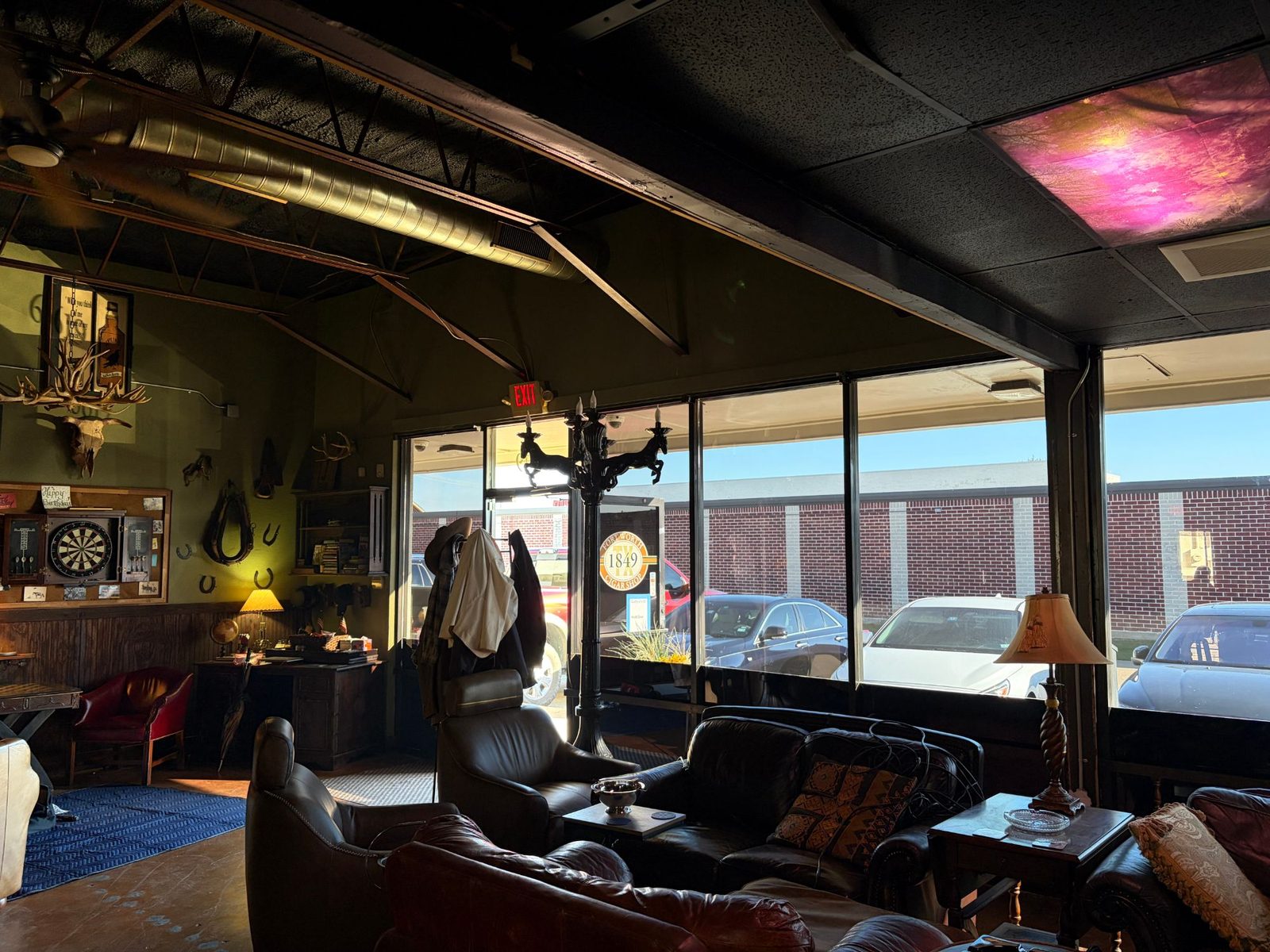Cigar lounge seating area behind tinted storefront glass