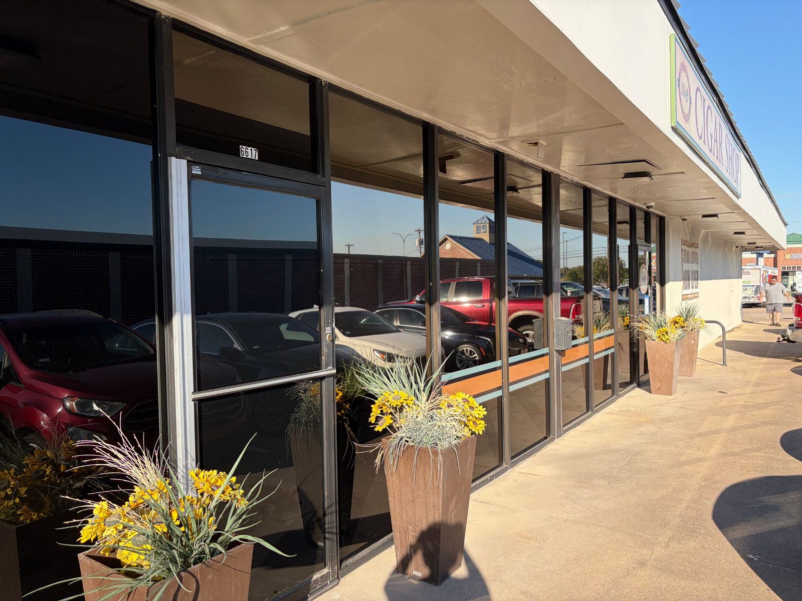 Row of tinted storefront windows along a Fort Worth strip center