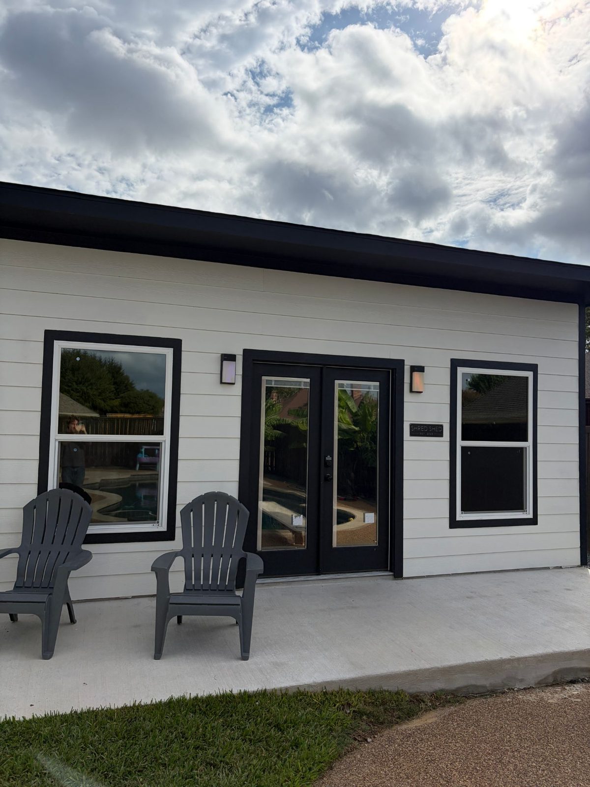 Backyard home gym with solar film on the windows and French doors
