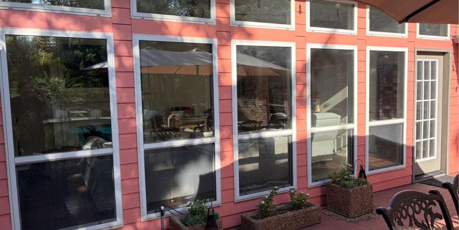 Same patio windows before privacy film, living room visible from outside
