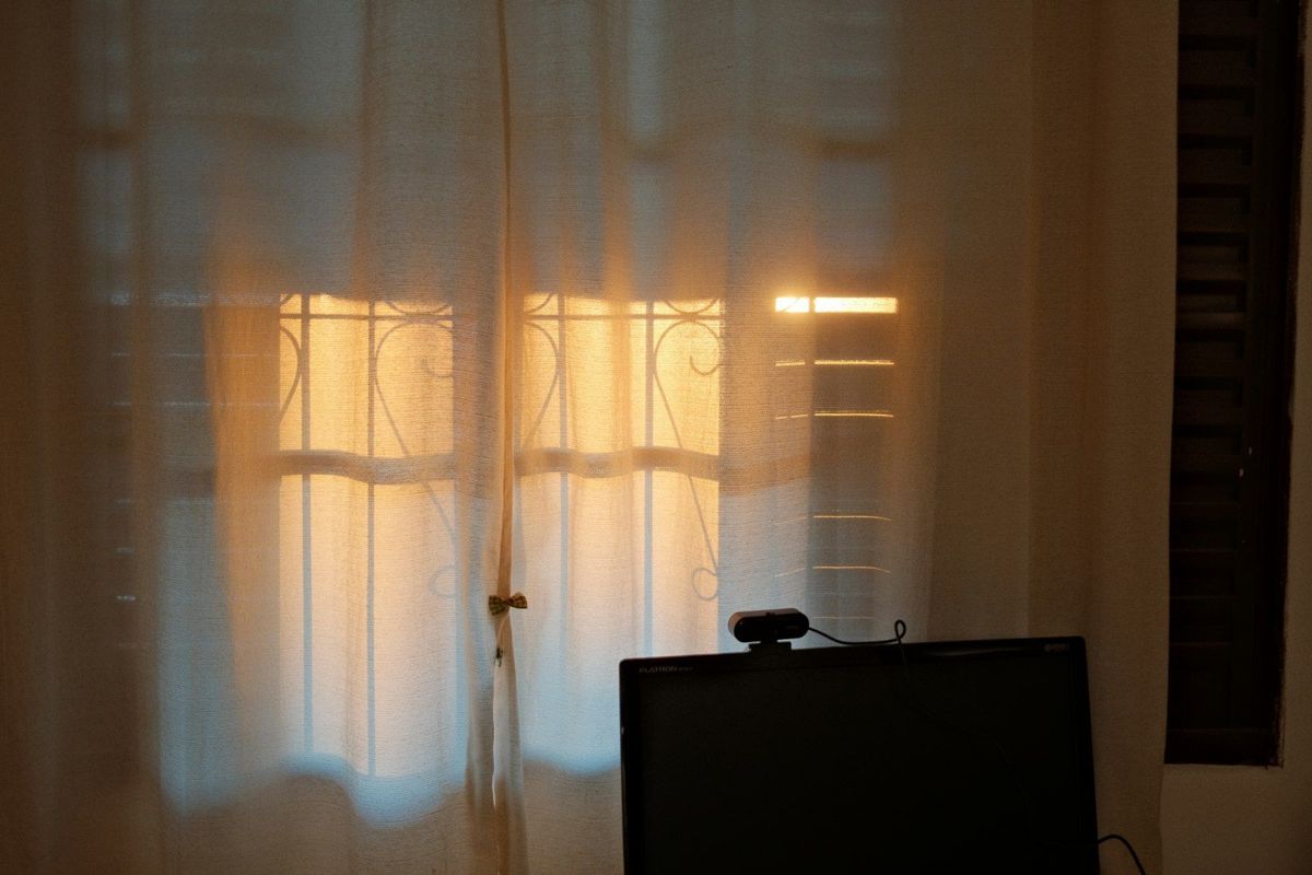Bright sun glaring behind a computer screen